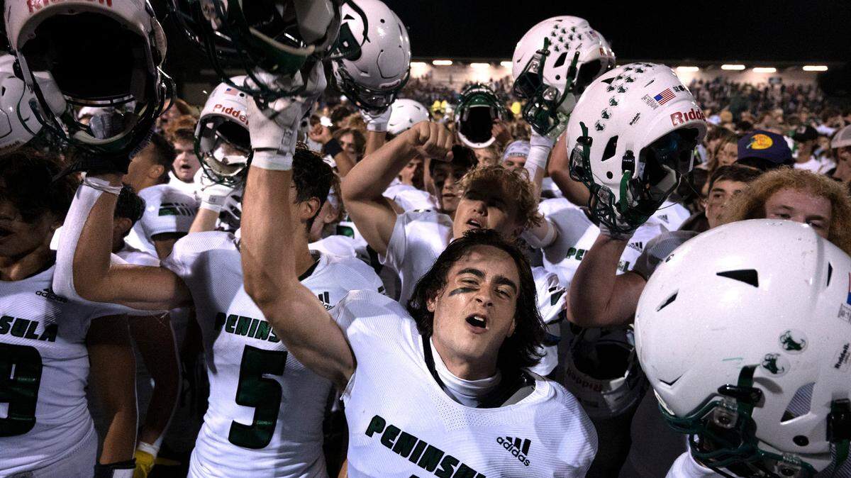 Peninsula senior wide receiver Gabe Haver-Brown leads the Seahawks in a post-game celebration following Friday night’s Fish Bowl crosstown rivalry football game at Roy Anderson Field in Purdy, Washington, on Sept. 16, 2022. Peninsula won the game, 39-30.