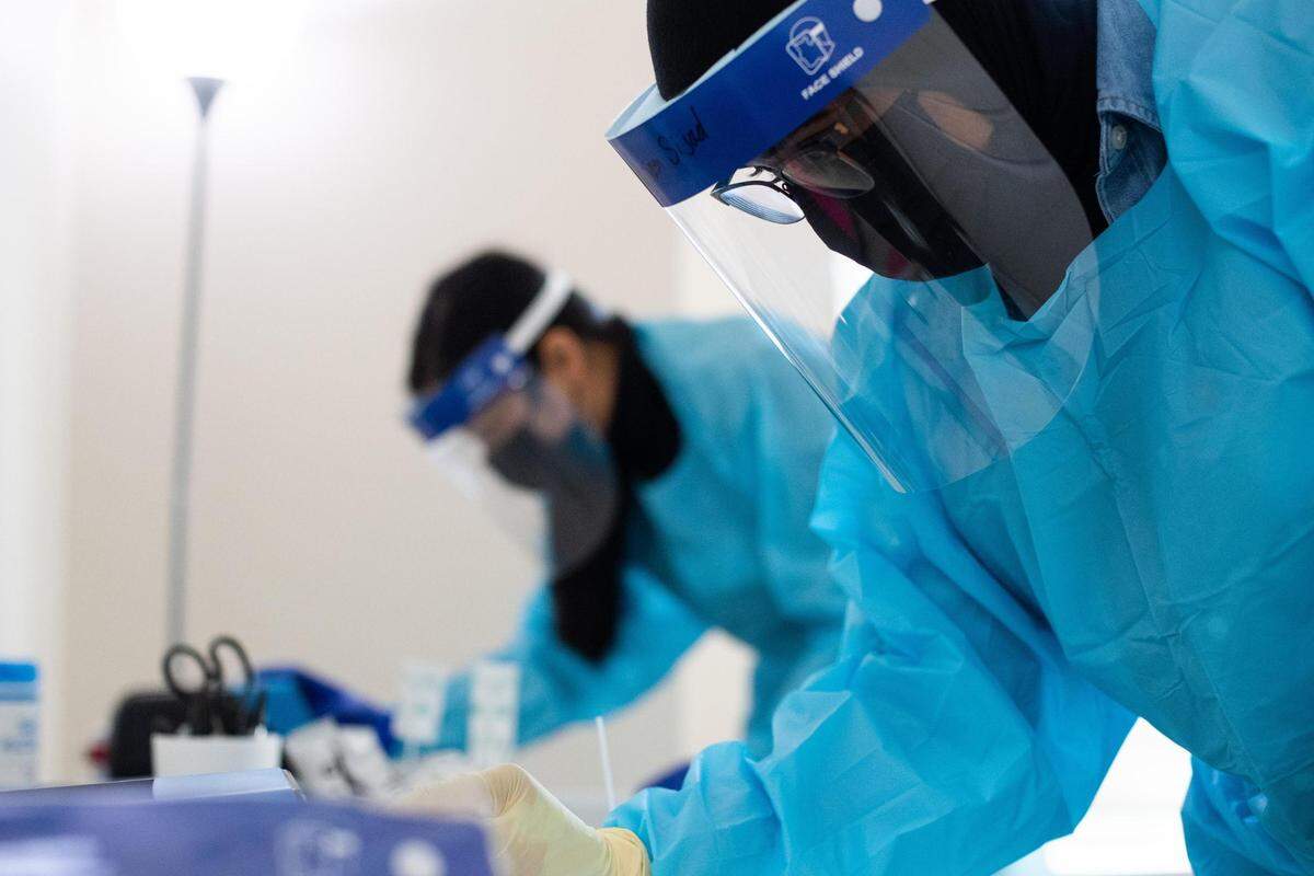 Mariam Sijad, a testing technician, prepares a sample for testing at GenCare Lifestyle at Point Ruston in Tacoma, Wash., on Friday, Jan. 22, 2021.