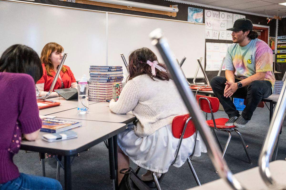 Orting High School Spanish teacher and culture club advisor Mauricio Portillo talks with a student during a culture club meeting in his classroom after school, on May 8, 2023. Portillo’s goal is to create a safe space for underrepresented students.