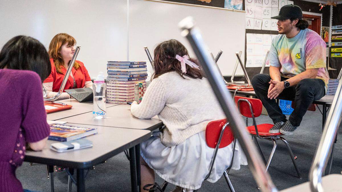 Orting High School Spanish teacher and culture club advisor Mauricio Portillo talks with a student during a culture club meeting in his classroom after school, on May 8, 2023. Portillo’s goal is to create a safe space for underrepresented students.