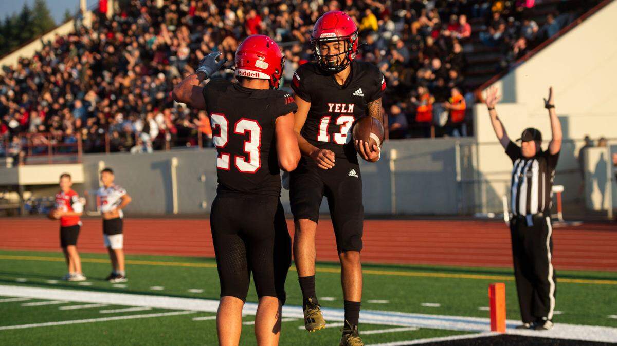 Yelm quarterback Palaina Hooper celebrates scoring a two-point conversion in the first quarter with Brayden Platt in the Tornados’ 34-18 win over the Abes Friday, Sept. 3, 2021.
