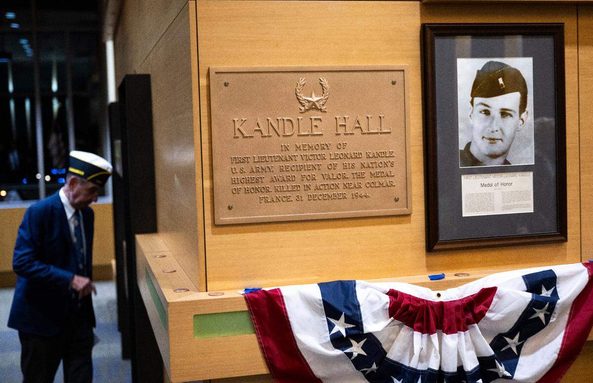 A restored plaque and photo of World War II soldier Lt. Victor Kandle hangs in the halls during a dedication ceremony to rename the lobby in honor of him at Puyallup City Hall, on Tuesday, Nov. 12, 2024 in Puyallup.