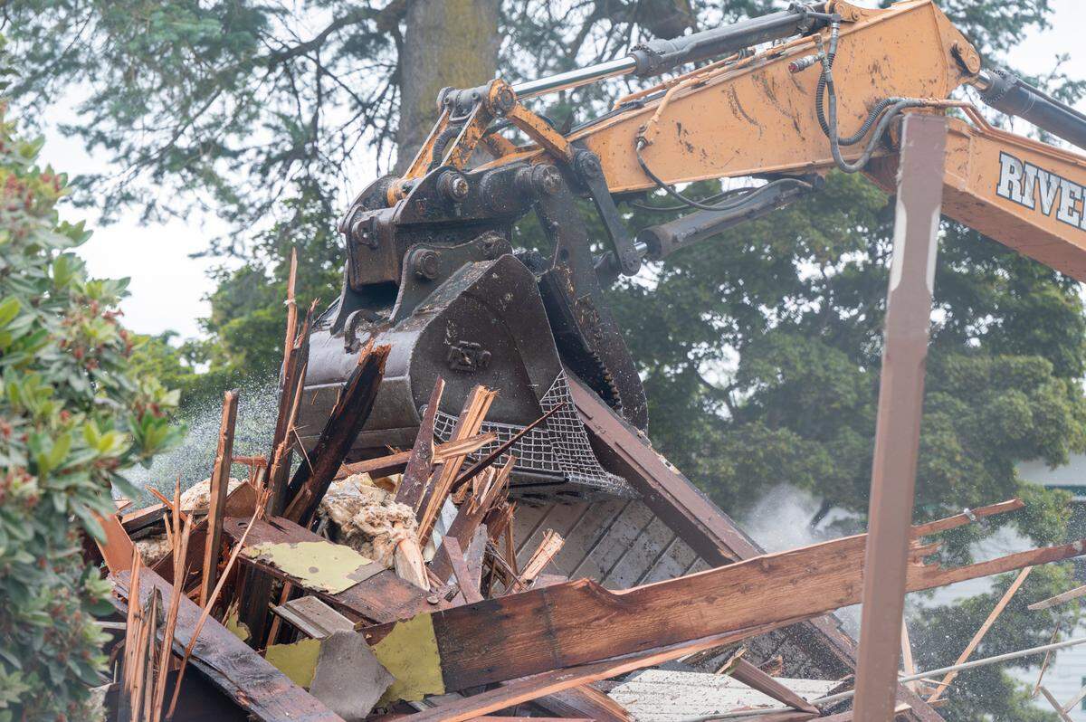 Wood and other pieces of the Ryan House are crushed as demolition takes place on the 160-year-old home on Friday, July 25, 2025, in Sumner, Wash.