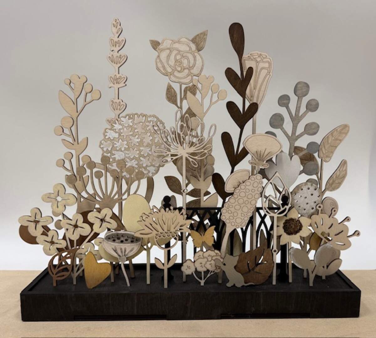 Maeberry Design specializes in laser-cutting and woodworking to create projects such as wooden floral arrangements.