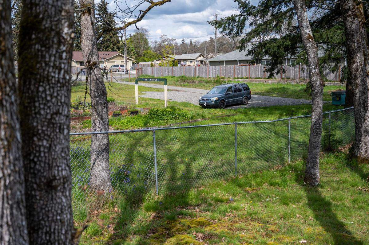 A car is parked in the Spanaway United Methodist Church’s safe parking lot area behind the church on Thursday, April 28, 2022 in Spanaway, Wash. The church became a part of the safe parking network around October of last year and have helped 29 people so far.