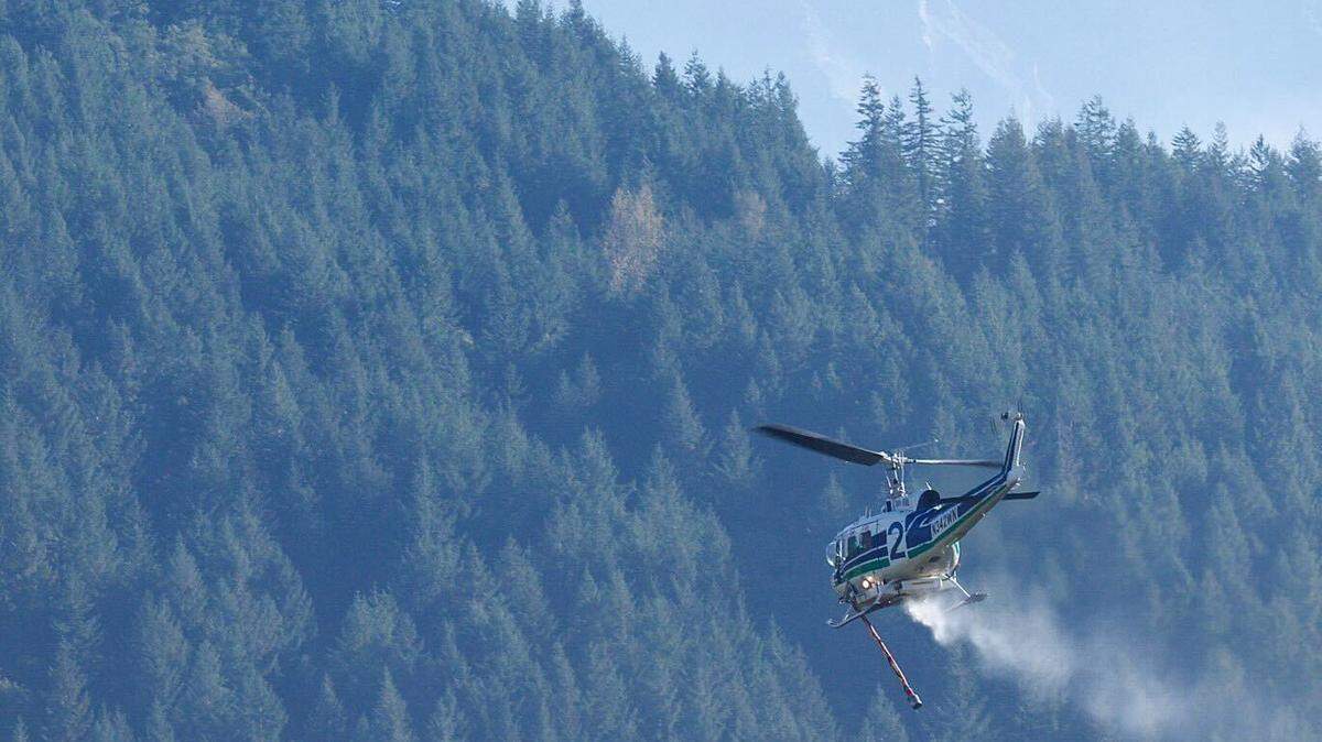 A helicopter drops water on the 8 Road Fire in Pierce County in an undated photograph from the Washington State Department of Natural Resources. The fire was first reported Saturday, Oct. 15, about four miles east of Eatonville.