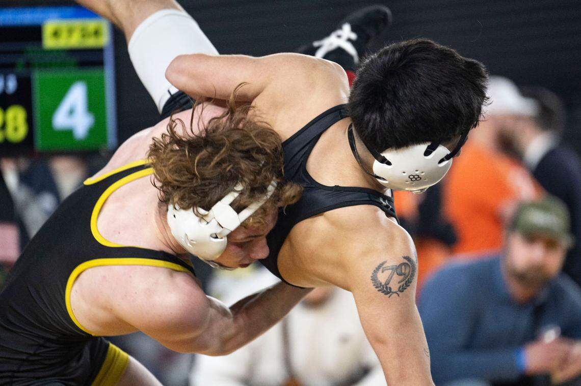 Tahoma’s Alex Othon tosses Davis’ Jacob Alcala to the mat during their Class 4A, 132-pound weight classification semifinal match on Friday, Feb. 21, 2025, at Mat Classic XXXVI at the Tacoma Dome in Tacoma, Wash.