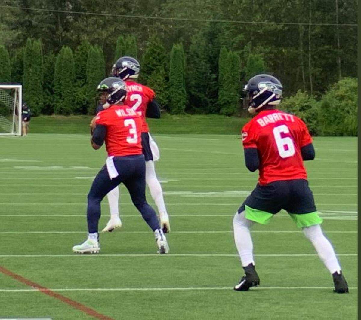 J.T. Barrett (6), on his first day of practice with the Seahawks, joins Russell Wilson (3) and Paxton Lynch (2) for drills on Sunday. It was the 12th practice of training camp.
