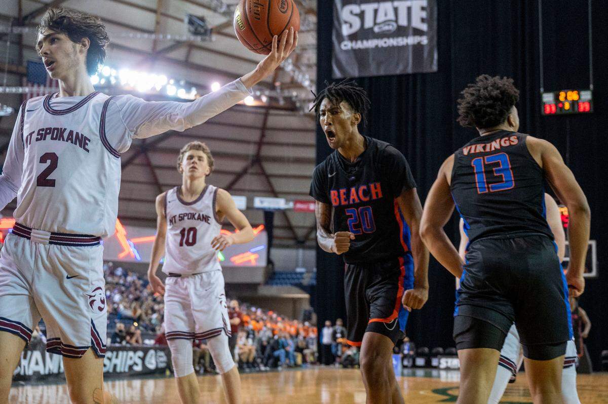 Rainier Beach forward Jaelin Green (20) celebrate after scoring a basket on an offensive rebound as Mount Spokane center David Roe (2) takes the ball out during the third quarter of a Class 3A semifinal state tournament game on Friday, March 4, 2022, at the Tacoma Dome, in Tacoma, Wash.