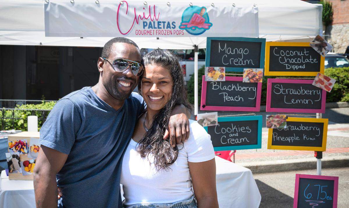 John and Amber Jones, pictured on Broadway on June 22, fell in love with paletas while visiting family in Puerto Rico. Find them at all three Tacoma Farmers Market locations.