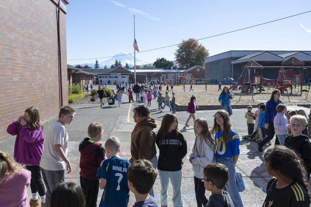 Orting Elementary School students and teachers move across the school's spread out cafeteria, portables and other buildings on Wednesday, Oct. 15, 2025, in Orting, Wash.