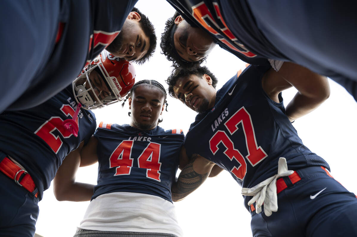 Lakes players pray before the game against Curtis at Harry Lang Stadium, on Friday, Sept. 19, 2025, in Lakewood.