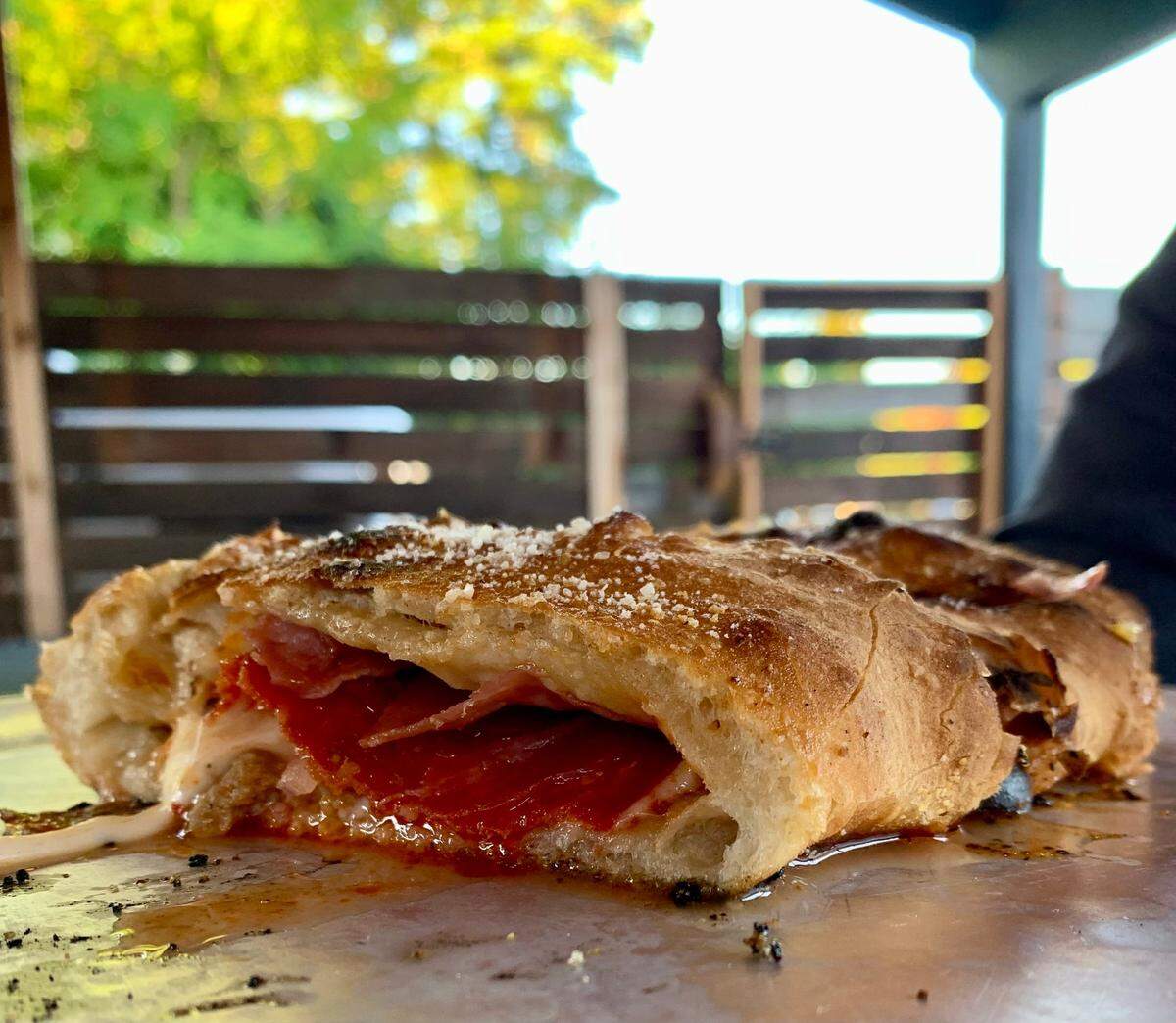 Parky’s Pizza Bar (colloquially still known as Parky’s Tavern) serves excellent bar pizza and calzones in Tacoma’s McKinley neighborhood. The early 20th-century bar was renovated by new owners and reopened in 2021, equipped with a secluded, fully fenced and covered back patio with a built-in fire pit.