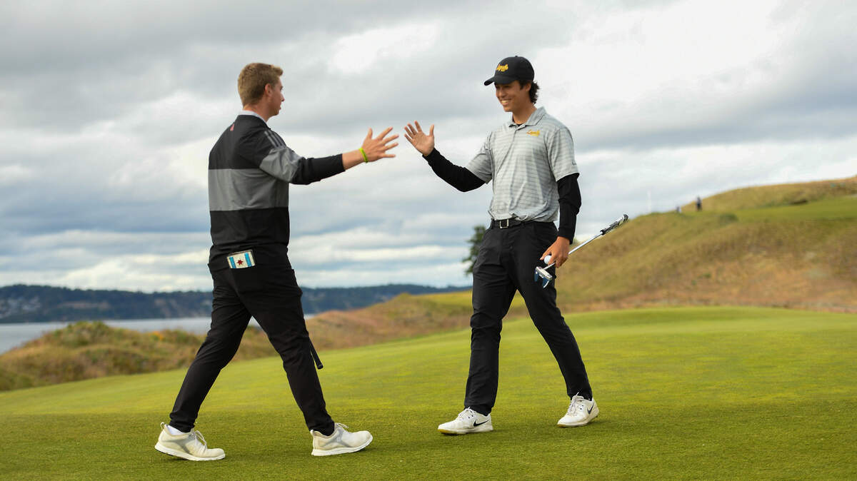 Devin Johnson, left, and Tyler Anderson celebrate their victory on the 17th green during the round of 32 at the 2021 U.S. Amateur Four-Ball at Chambers Bay in University Place, Wash. on Monday, May 24, 2021. (Robert Beck/USGA)