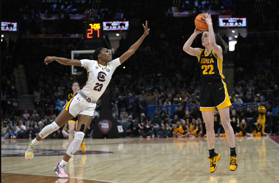 Iowa superstar Caitlin Clark (22) shoots over South Carolina’s Bree Hall (23 in white) in the first half of the NCAA women’s tournament championship game April 7, 2024, in Cleveland. Clark, the all-time leading scorer in Division-I women’s or men’s basketball, finished the game with 30 points, but South Carolina won the game and the national title.