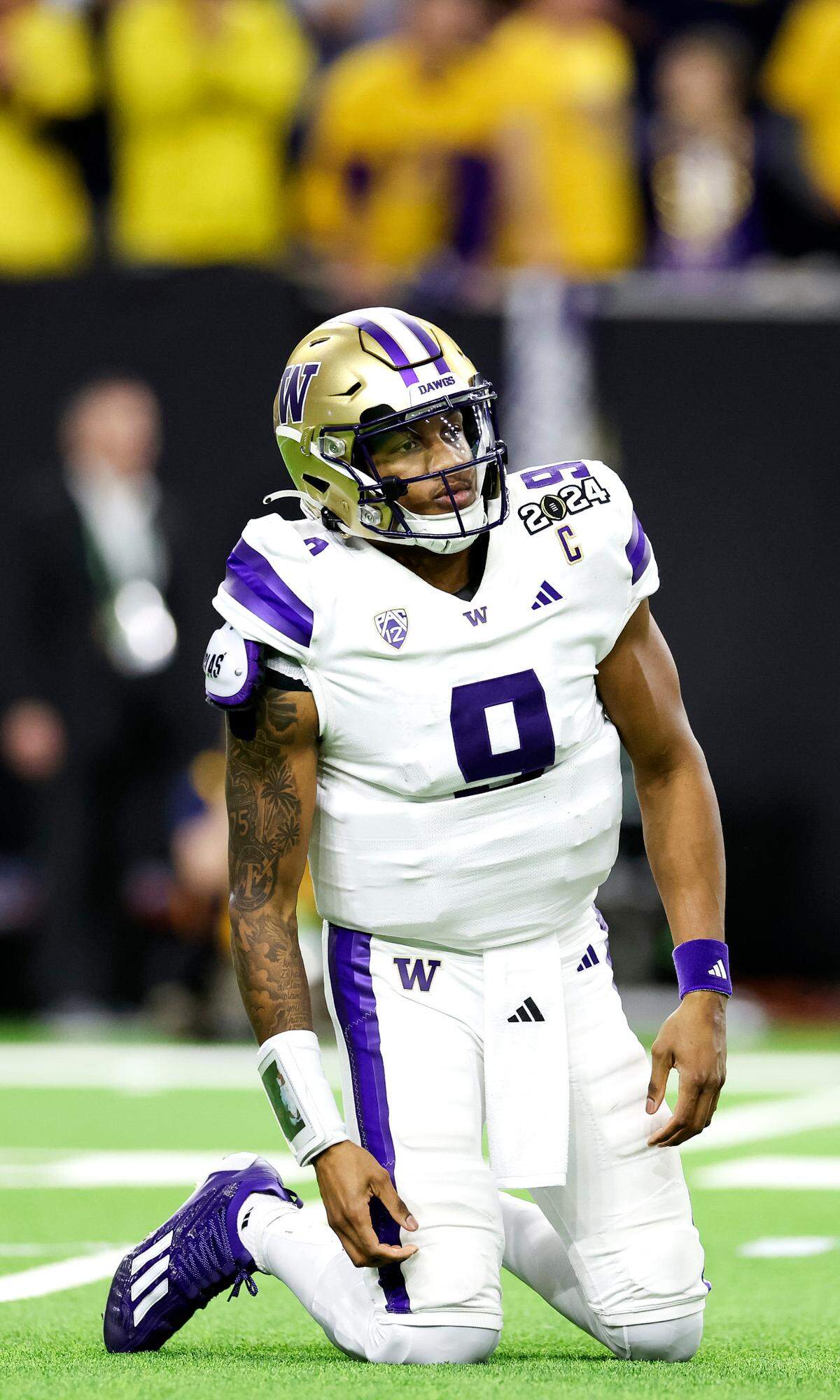 Washington Huskies quarterback Michael Penix Jr. (9) reacts after taking a hit during the fourth quarter of the College Football Playoff National Championship game against the Michigan Wolverines at NRG Stadium on Monday, Jan. 8, 2024, in Houston.