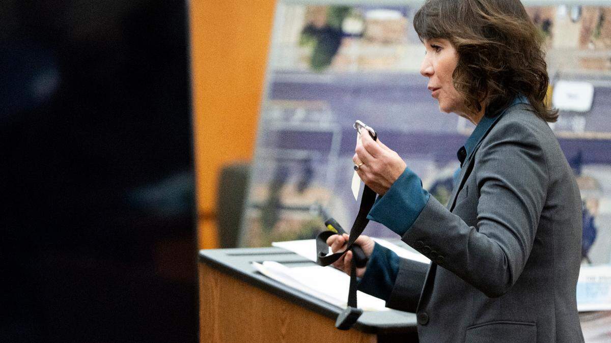 Special Assistant Attorney General Patty Eakes holds up the hobble strap used on Manny Ellis while giving closing arguments during the trial of three Tacoma Police officers in the killing of Manny Ellis at Pierce County Superior Court, Monday, Dec. 11, 2023, in Tacoma, Wash. Tacoma Police Officers Christopher Burbank, Matthew Collins and Timothy Rankine stand trial for charges related to the March 2020 killing of Manny Ellis. (Brian Hayes / Pool Photo – The News Tribune)