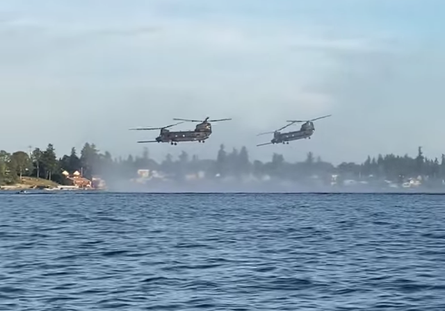 Two Chinook helicopters from Joint Base Lewis McChord fly over American Lake in Lakewood on Wednesday, June 7. A 45-year-old man was arrested for allegedly shooting at them.