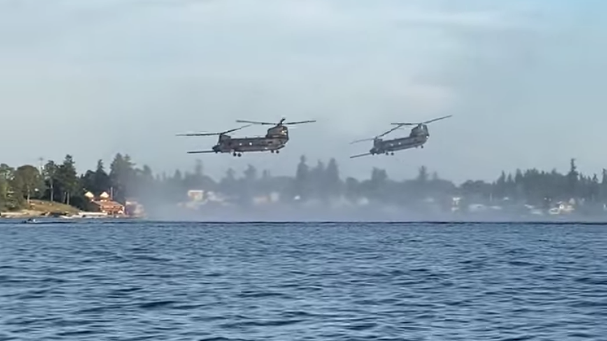 Two Chinook helicopters from Joint Base Lewis-McChord fly over American Lake in this file photo. A JBLM service member drowned in the lake on Monday, July 15.