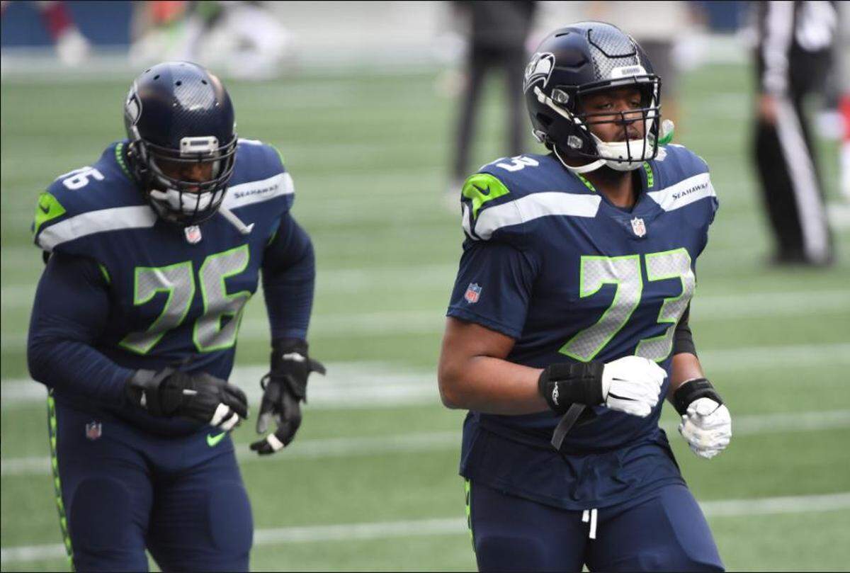 Jamarco Jones (73) and fellow tackle Duane Brown during Seahawks pregame warmups before Sunday’s game against the New York Giants at Lumen Field in Seattle. Jones was poised to start at right tackle because starter Brandon Shell (ankle) and fill-in Cedric Ogbuehi (calf) were inactive.