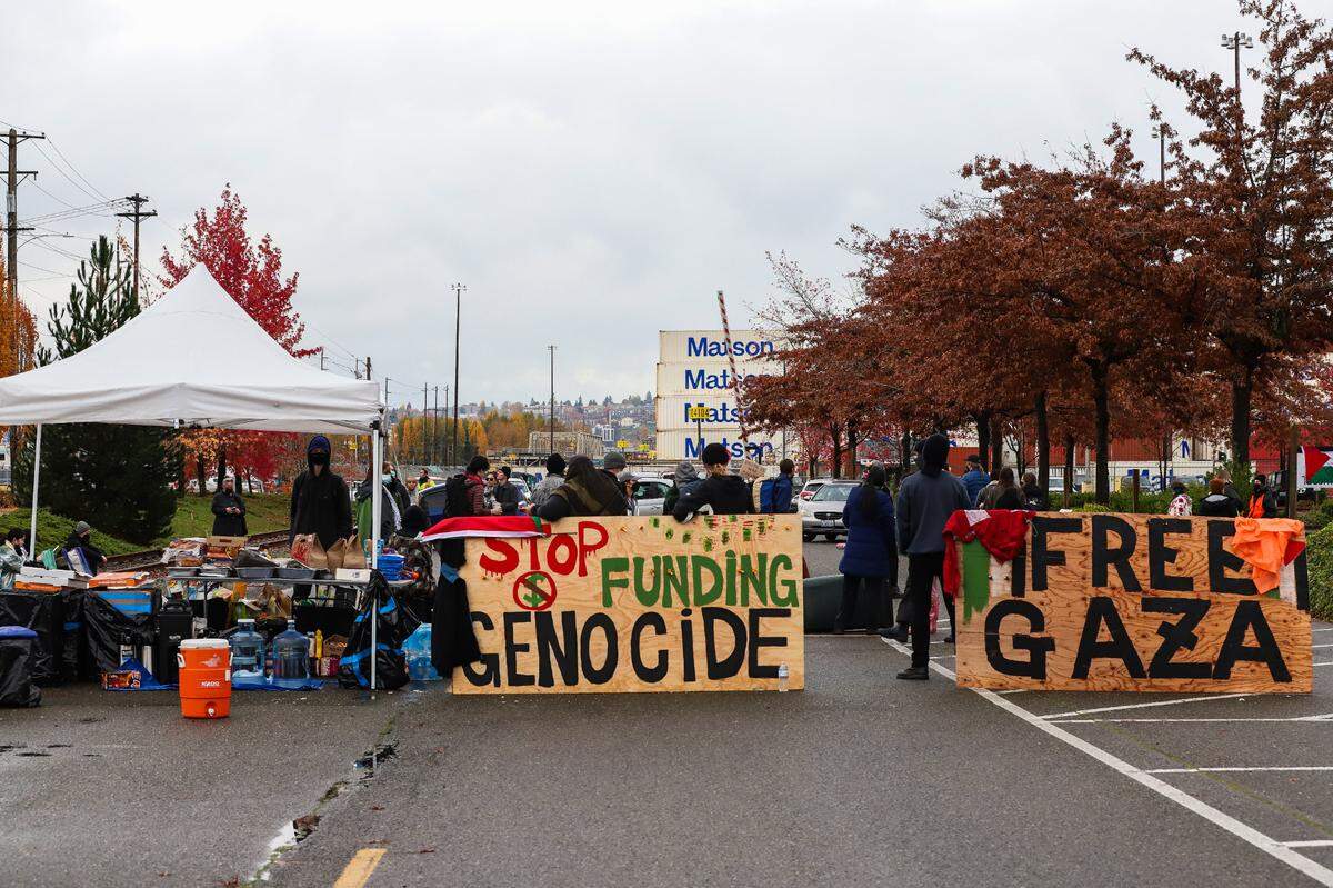 Protesters block the entrance to a pier on the Port of Tacoma to block the MV Cape Orlando from departing on Monday, November 6, 2023. Protesters believed the ship was being loaded with weapons and equipment that was to be delivered to Israel.