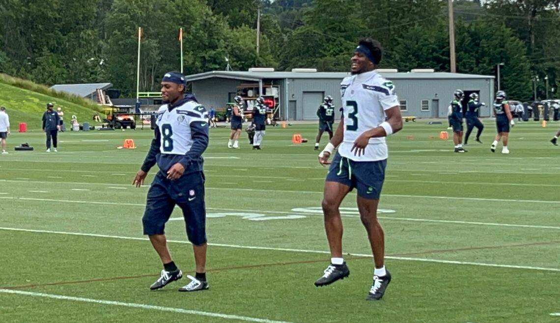 Veteran safety Coby Bryant (8) and rookie second-round NFL draft choice Nick Emmanwori (3) joke during their warmups for the fourth practice of Seattle Seahawks organized team activities (OTAs) June 4, 2025, at the Virginia Mason Athletic Center in Renton.