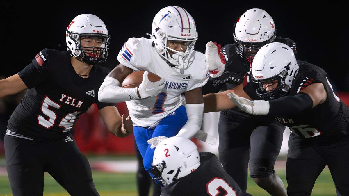 Graham Kapowsin wide receiver Khristian Norris runs against Yelm defenders (clocklwise from left) Mason McCormick, Bol Bol, Chris Hauss and Gunner Westbrook during Friday night’s football game at Yelm High School in Yelm, Washington, on Oct. 4, 2024.