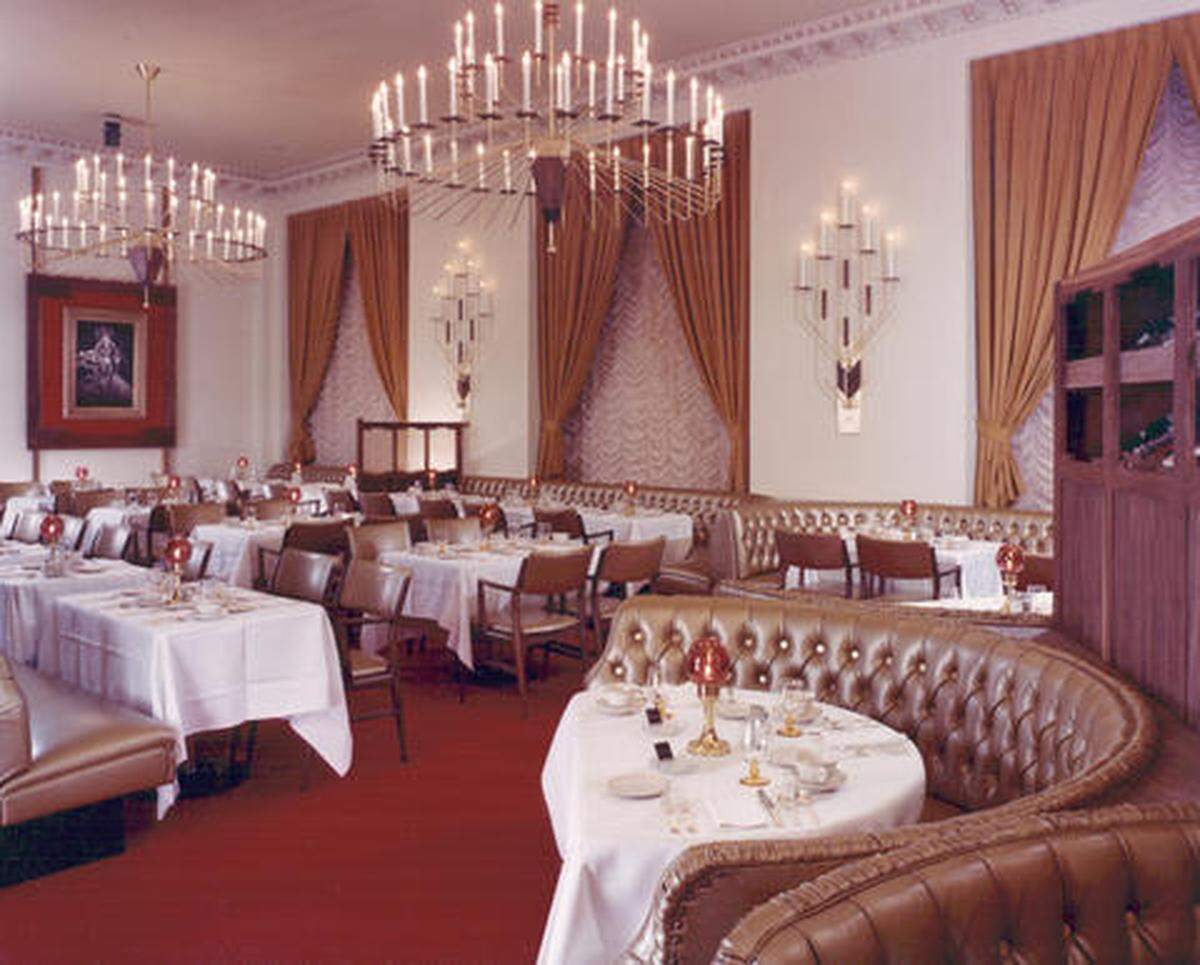 Color photograph taken in May, 1963, of the elegant Three Keys restaurant. Managed by Max Jaunzems, the Three Keys was located in the Winthrop Hotel. Decorated in subdued earth tone shades, the restaurant would have provided comfortable dining under the soft lighting of chandeliers and sconces. The main dining area had been re-named the “Three Keys” by new hotel owner/manager William Hamman to stand for the three keys to fine dining: carefully prepared food, properly aged wines and excellent service. The $65,000 remodeling project included gold tufted banquettes and curved settees.