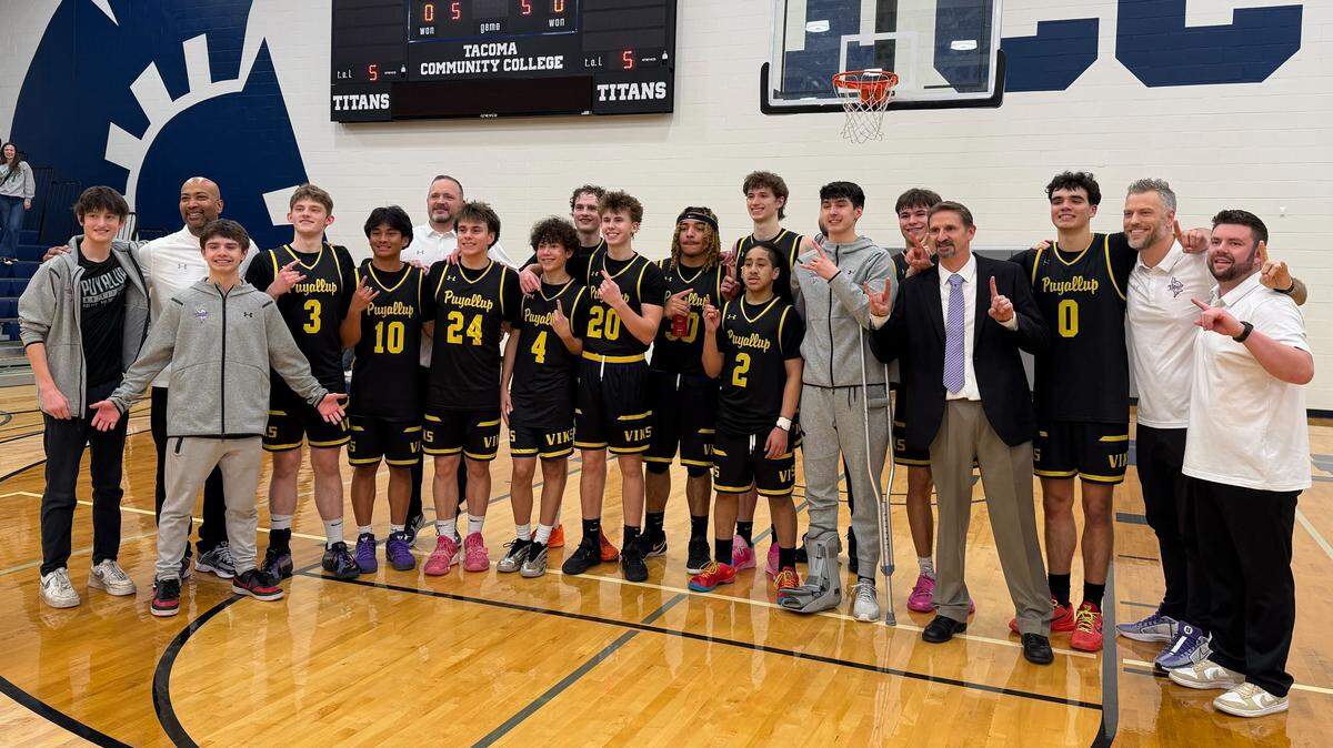 The Puyallup Vikings pose for a portrait after capturing the 4A SPSL basketball title in a 65-60 win over Emerald Ridge on Feb. 7, 2026, at Tacoma Community College.