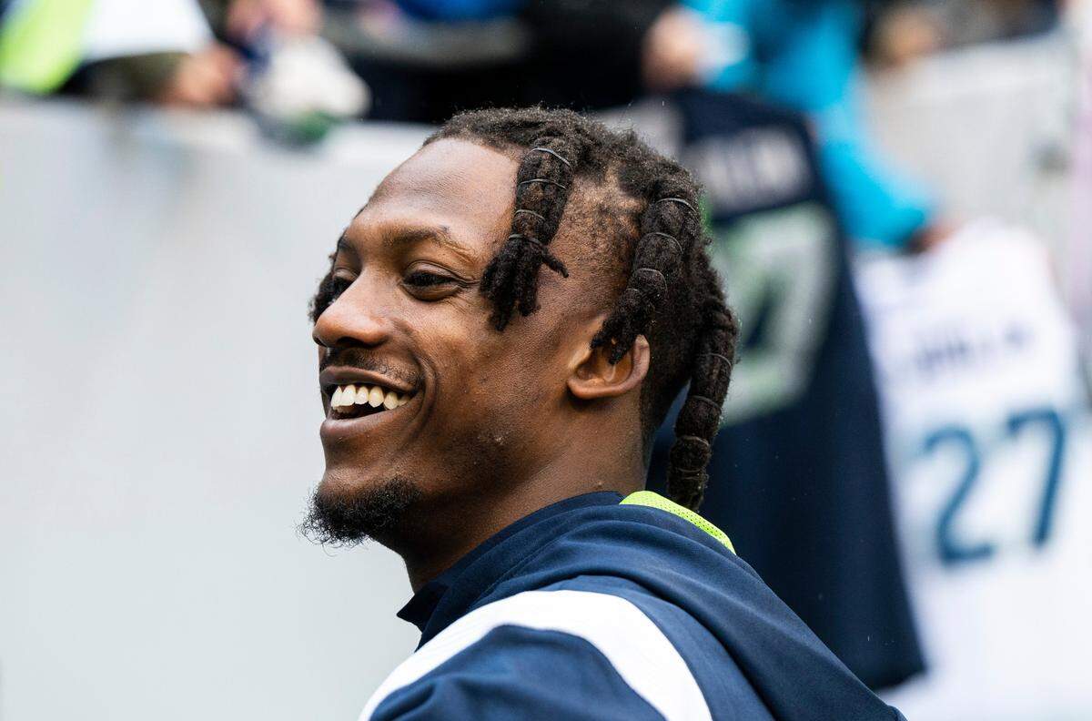 Seattle Seahawks cornerback Tariq Woolen (27) signs fans’ jerseys before the start of an NFL game against the California Panthers at Lumen Field in Seattle Wash., on Dec. 11, 2022.