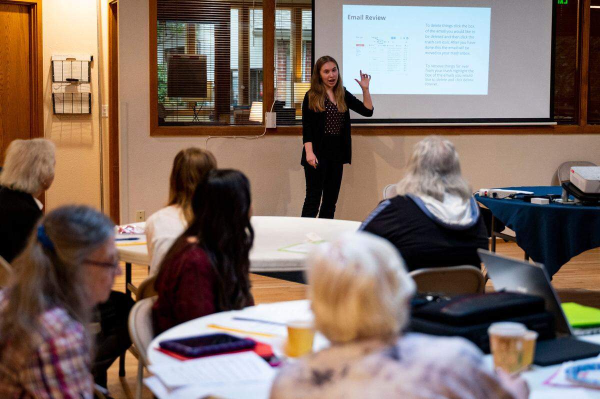 Rylee Harwood, a sophomore at Fife High School and member of the school Future Business Leaders of America, presents the steps to send an email to a class of seniors at the Milton Activity Center on Friday, Oct. 21, 2022, in Milton, Wash. Fife High School’s FBLA program hosts a free monthly workshop directed toward seniors in the community to teach them how to navigate commonly-used devices such as smartphones and laptops.