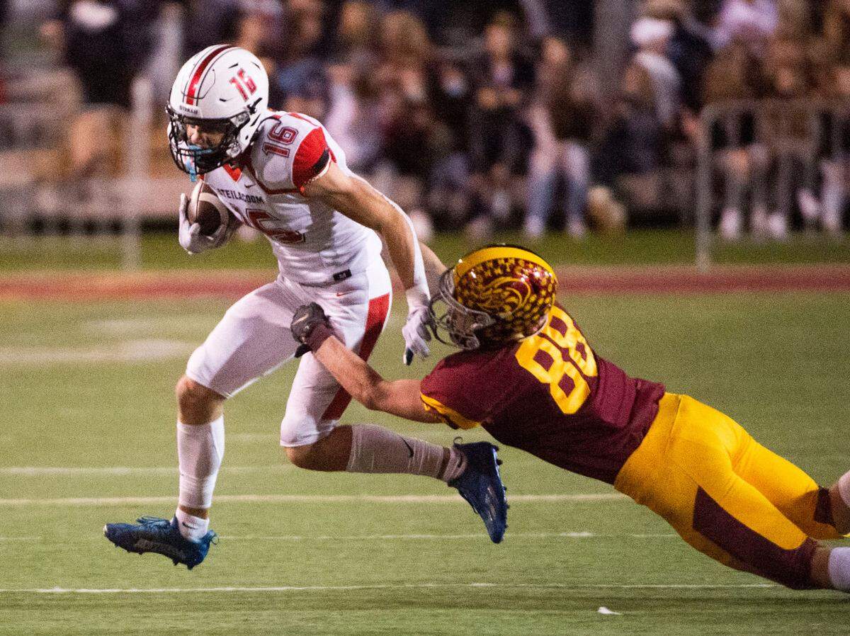 Sentinels receiver Cole Miller is tackled by Hornets linebacker Austin Paulson. The Steilacoom Sentinels football beat the Enumclaw Hornets, 14-7, in a 2A South Puget Sound League game on Friday night, Oct. 9, 2021 at Pete’s Pool in Enumclaw.