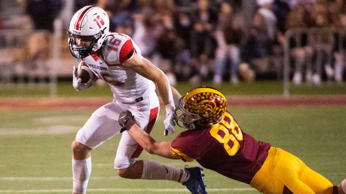 Sentinels receiver Cole Miller is tackled by Hornets linebacker Austin Paulson. The Steilacoom Sentinels football beat the Enumclaw Hornets, 14-7, in a 2A South Puget Sound League game on Friday night, Oct. 9, 2021 at Pete’s Pool in Enumclaw.