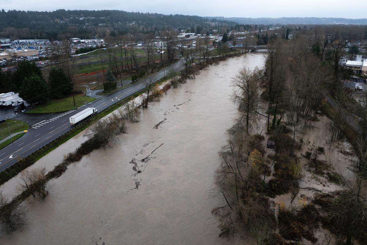 Water flows over the banks of the Puyallup River near the Golden Rose 55+ Community in Puyallup, Wash., on Wednesday, Dec. 10, 2025.