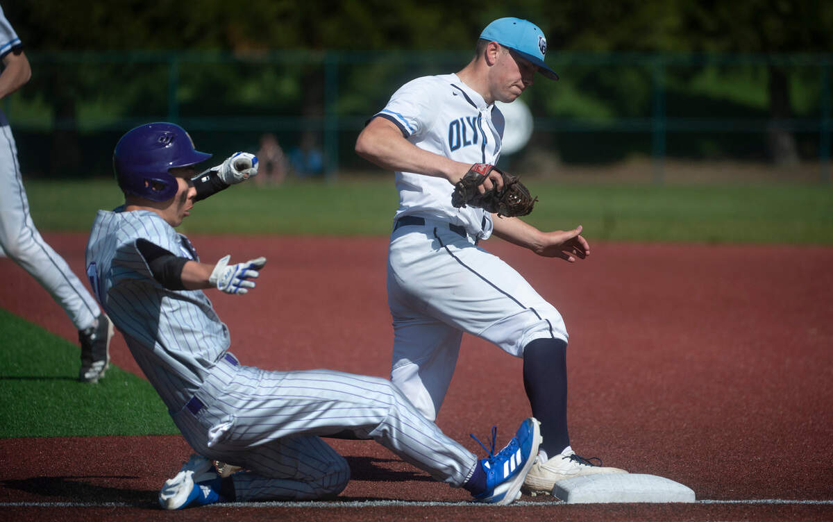Olympia pitcher Taber Fast forces beats Issaquah hitter Adam Kim to first base for the force out during the quarterfinal round of the 4A state baseball tournament at the Regional Athletic Complex in Lacey, Washington, on Saturday, May 22, 2022.