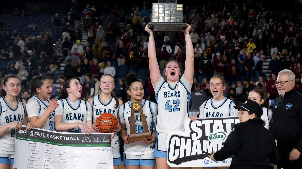 Central Valley forward Brynn McGaughy (42) hoists the Class 3A Girls Basketball Championship trophy after the Bears beat Lakeside, 39-34, at the Tacoma Dome on Saturday, March 8, 2025, in Tacoma, Wash.