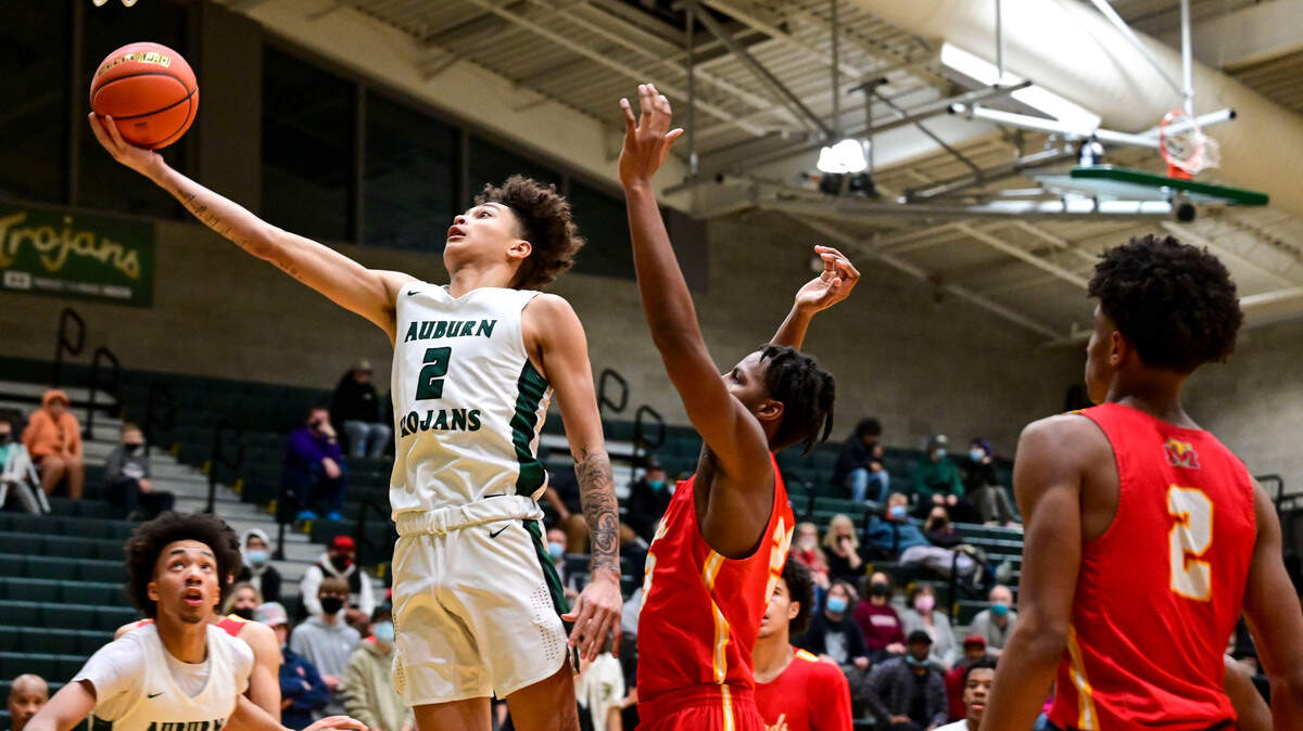 Auburn guard Trevon Blassingame (2) drives to the basket for a layup as Mount Tahoma forward Damian Laffitte II (23) defends during the third quarter of a non-league game on Thursday, Jan. 20, 2022, at Auburn High School.