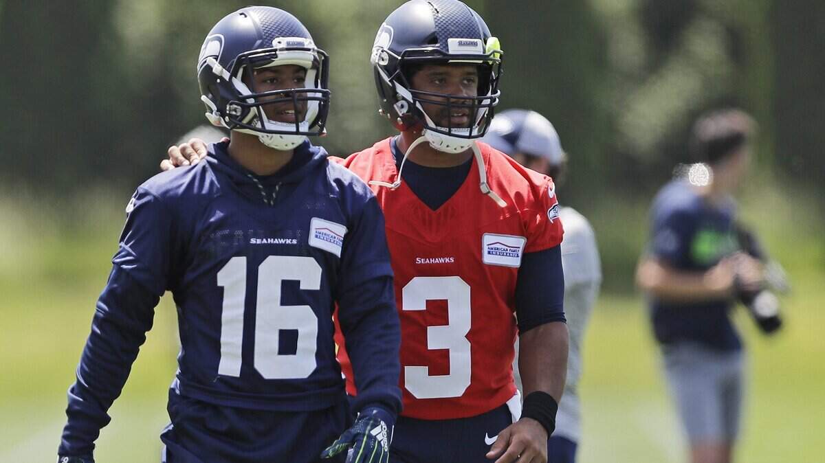 Seattle Seahawks quarterback Russell Wilson (3) walks off the field with wide receiver Tyler Lockett (16) following an organized team activity Tuesday, June 4, 2019, at the team’s NFL football training facility in Renton, Wash. (AP Photo/Ted S. Warren)