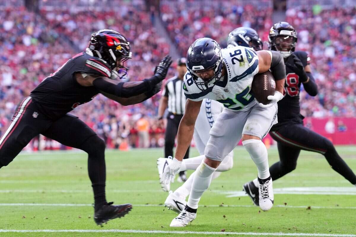 Seattle Seahawks running back Zach Charbonnet (26) runs for a touchdown against the Arizona Cardinals during the first half at State Farm Stadium. Mandatory Credit: Joe Camporeale-Imagn Images