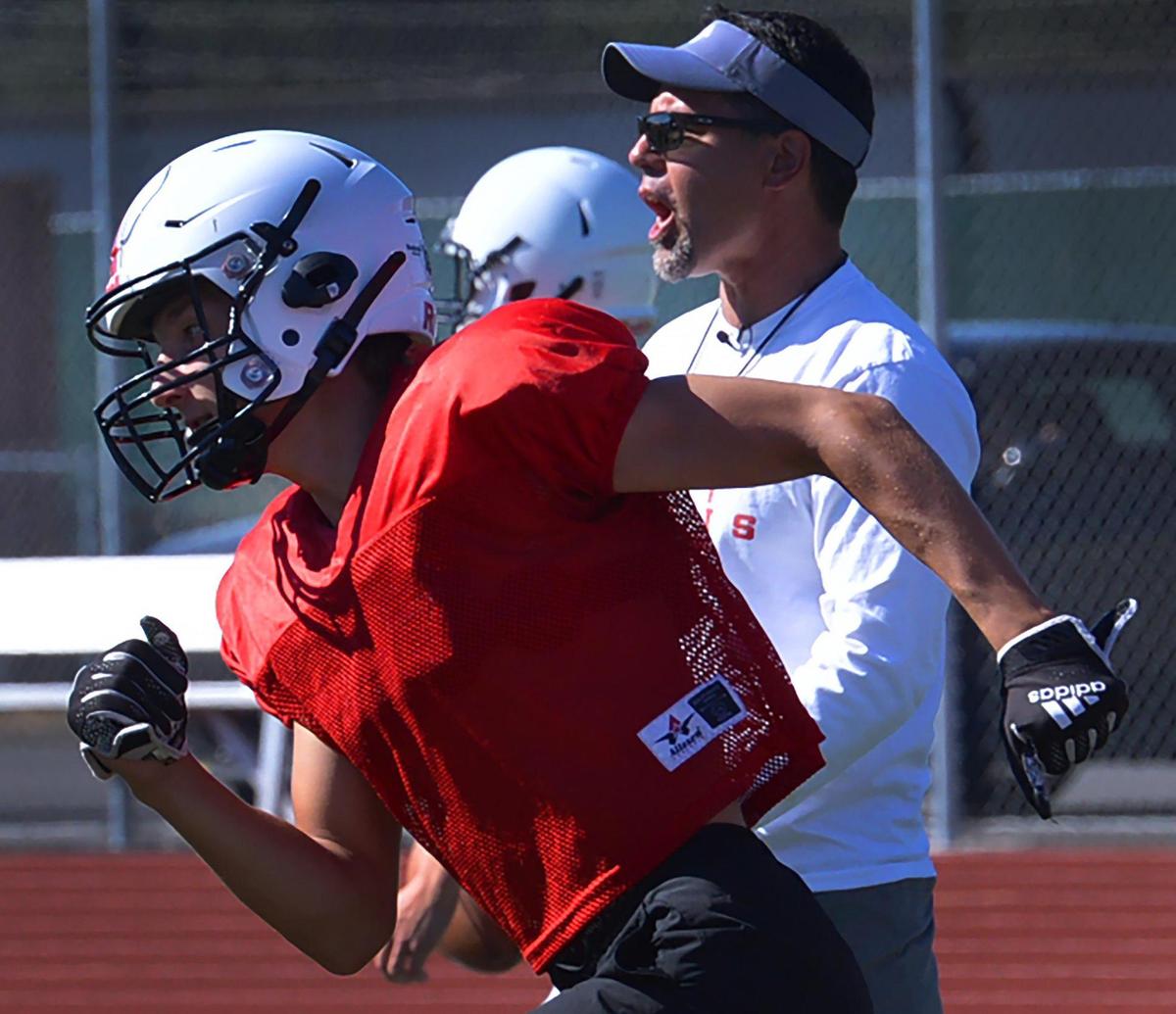 Yelm head coach Jason Ronquillo directs afternoon practice on Monday, August 22 as the Tornados prepare for the 2022 season