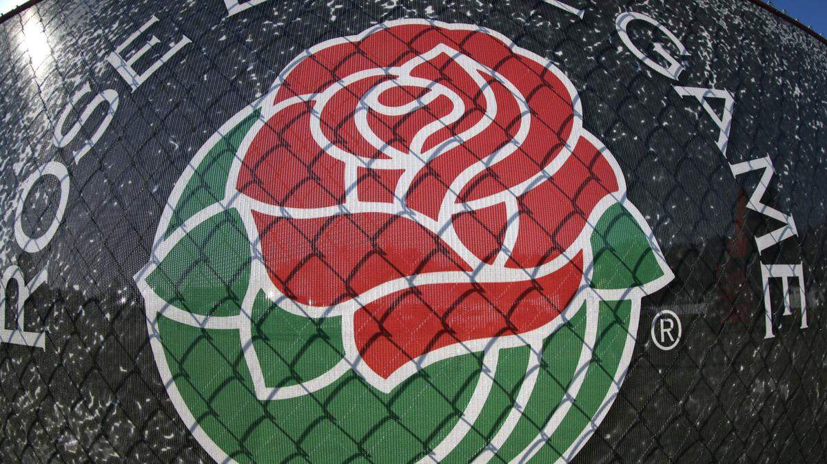 The Rose Bowl logo appears on a fence outside the stadium at the Rose Bowl NCAA college football playoff semifinal, Thursday, Jan. 1, 2015 in Pasadena, Calif. (AP Photo/Jae C. Hong)