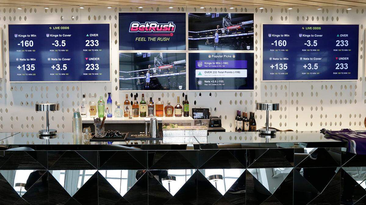 Video screens display the types of bets that could be placed at the Golden 1 Center’s Skyloft Predictive Gaming Lounge, in Sacramento, Calif., in 2019. Gov. Jay Inslee signed 15 tribal sports wagering compacts this week​, the most recent step in paving the way for Washington state tribes to begin allowing sports betting at tribal casinos.