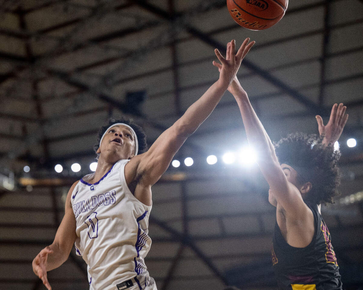 Garfield guard Myles Daymon (0) attempts a layup as O’Dea guard Brian Webster (12) defends during the first quarter of the Class 3A championship game on Saturday, March 4, 2023, in Tacoma, Wash.