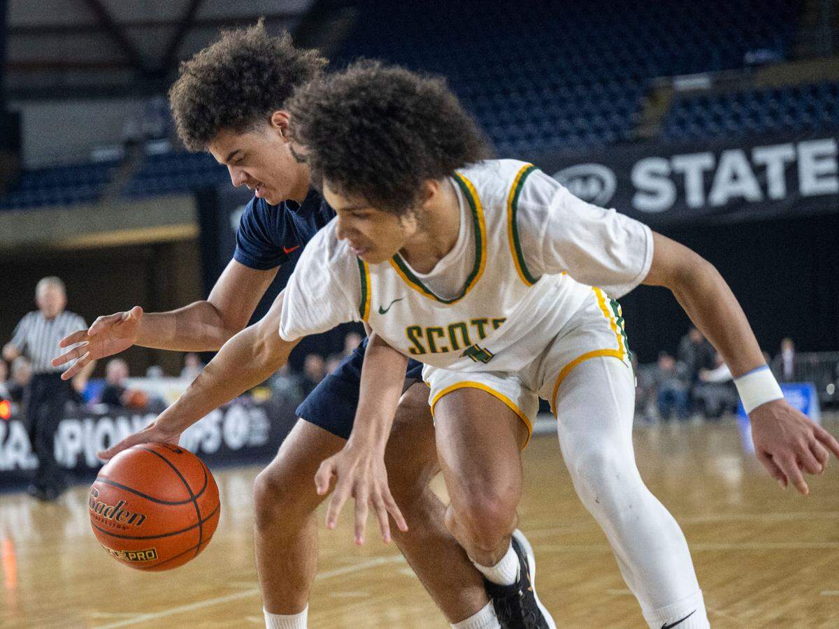Eastside Catholic guard Tate Dawson (2) and Shorecrest guard Keaine Silimon (1) fight for a loose ball under the basket during the fourth quarter of a Class 3A consolation game on Friday, March 3, 2023, in Tacoma, Wash.