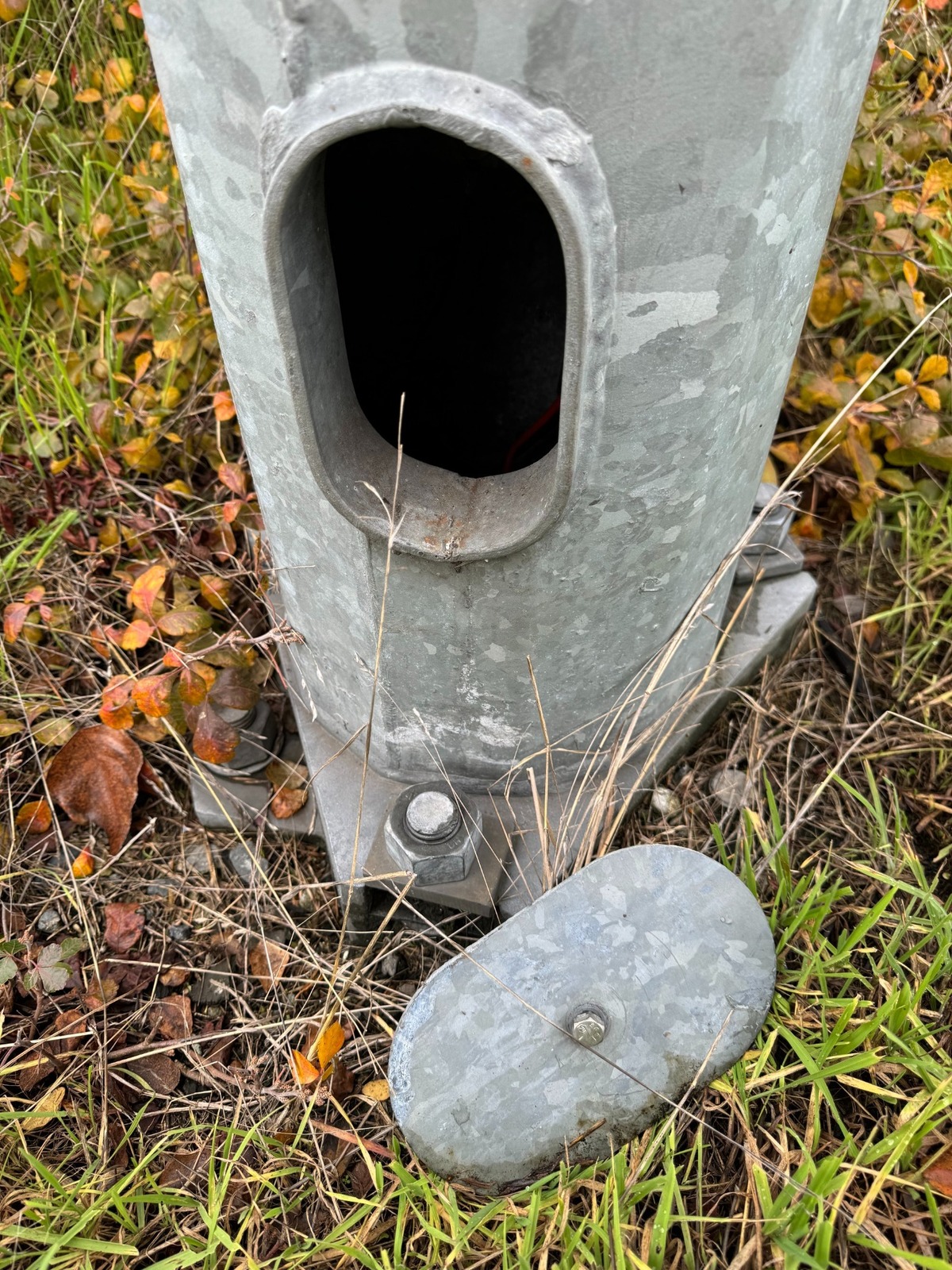 A plundered streetlight pole along state Route 16 in Tacoma has been stripped by thieves of its copper wiring.