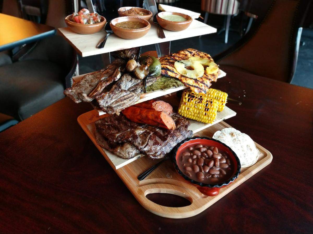 A meat tower is an efficient way to explore the grilled meats at Ta Carbon in Tacoma. This platter is called the Ta Carbonada and includes short ribs, carne asada, grilled cactus, chicken, chorizo, beans, salsas, roasted corn and tortillas.