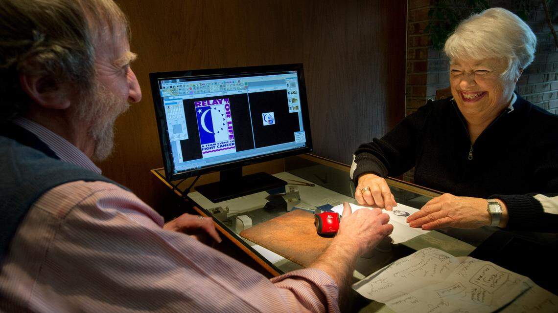 Pat Flynn looks at a Relay for Life pendant created for her by Steph Farber of LeRoy Jewelers on Feb. 27, 2014. Flynn, known as the "Mother of Relay" for her work in getting the American Cancer Society's fundraiser off the ground, died Saturday.