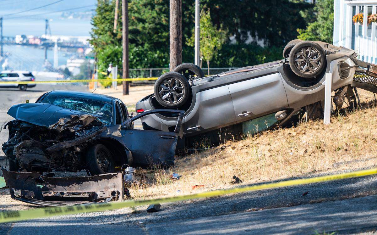 A view of the scene where a woman was killed after the driver of the sedan ran the stop sign at the intersection and crashed into the minivan, causing it to flip, at the corner of East 34th Street and East D Street in Tacoma, Wash. Sept. 1, 2022. The sedan was a stolen vehicle and the driver fled the scene.