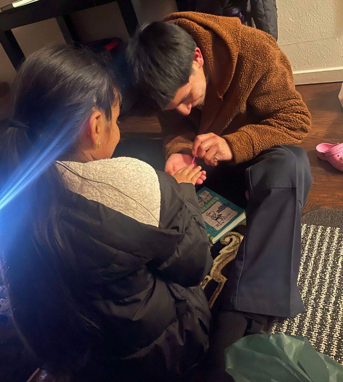 Jonathan Tovar painting his oldest niece’s nails. His sister, Clara Tovar, said her brother enjoyed spending time with his nieces.