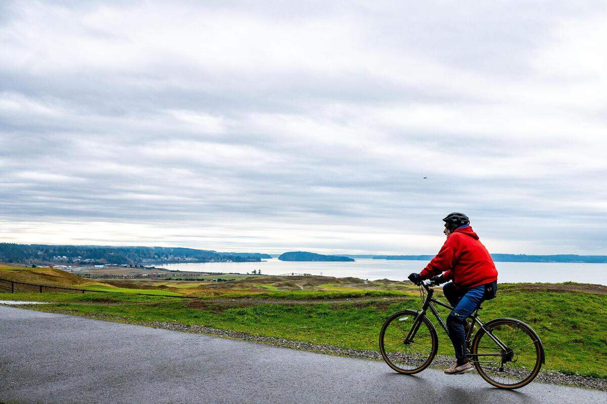 A cyclists pedals along the trail above Chambers Bay on a Monday, Jan. 10, 2022, in University Place, Wash.